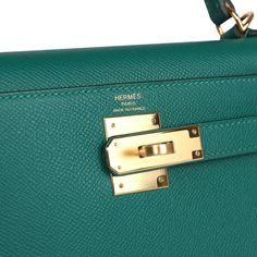 This Kelly, in the Sellier style, is in Malachite epsom leather with gold hardware and has tonal stitching, front flap with two straps, front toggle closure, clochette with lock and two keys, and single rolled handle.The interior is lined in Malachite chevre leather.Collection: YOrigin: FranceCondition: New and never worn (plastic on hardware)Accompanied by: Hermes box, Hermes dustbag, lock, 2 keys, clochette, clochette dustbag, strap, strap dustbag, felt, rainhat and carebookMeasurements: 11.25" width x 8.25" height x 4.75" depth; 3.5" handle drop (16.5" shoulder strap drop) Formal Epsom Leather Bag With Brass Hardware, Hermes Malachite, Blue Mini Kelly, Emerald Green Hermes Bag, Hermes Kelly Retourne, Hermes Kelly Limited Edition, Hermes Kelly 28, Hermes Birkin 25, Hermes Constance