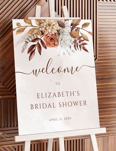 a welcome sign for the bride and groom on a wooden easel with floral accents