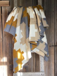 a blanket hanging on the side of a wooden wall