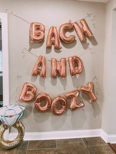 balloons that say back and boozy are hanging on the wall in front of a door