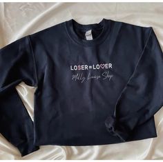 "Loser = Lover Embroidered Sweatshirt!  -Embroidered on a cotton/polyester blend crewneck sweatshirt, this design is simple and minimalistic, perfect for every outfit! -Embroidery design measures 1.5x 5\". -See product pictures for shirt sizing chart. **SWEATSHIRTS ARE IN UNISEX SIZING AND RUN TRUE TO SIZE. -All sweatshirts are handmade on an embroidery machine so there may be slight differences, but we only sell the sweatshirts that meet our high-quality standards. -To maintain the quality of your sweatshirt and the embroidery design make sure to wash with care. We recommend turning the item inside out and using a cold wash and delicate cycle. We highly recommend air drying when possible as well. -Please feel free to reach out with any additional questions, customization requests, etc. We Casual Black Sweater With Embroidered Text, Black Cotton Sweater With Embroidered Text, Black Embroidered Text Sweatshirt Crew Neck, Black Cotton Sweater With Letter Embroidery, Sweat Shirts, Embroidered Sweatshirt, Product Pictures, Embroidered Sweatshirts, Sizing Chart