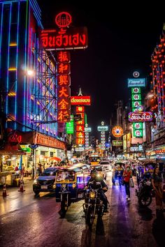 a busy city street at night with neon lights