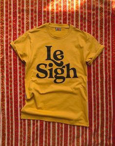 Le Sighhhhhhhh. I'm always sighing for all kinds of reasons, le reasons if you will. Unisex Antique Gold tee printed with black ink see last photo for sizing information 5.6 oz., 100% cotton Pre-shrunk Relaxed fit Suitcase Ii, Tshirts Cute, Tee Shirt Outfit, Retro Minimalist, Golden Shadow, Xmas Ideas, Soccer Mom, Look Vintage, Shirt Ideas