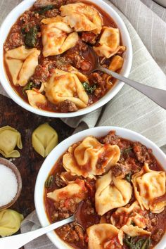 two white bowls filled with pasta and meat