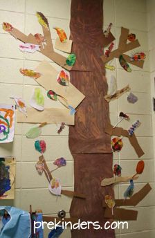 a tree made out of paper on the side of a wall in a school room