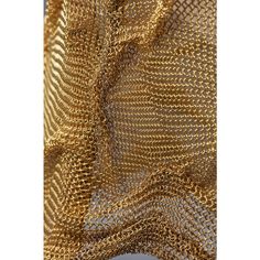 gold metallic mesh fabric with wavy lines on the bottom and sides, as well as an image