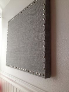 a wall hanging on the side of a white wall next to a radiator