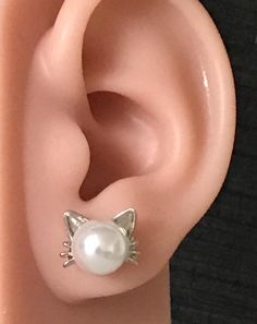 These Elegant Stainless Steel and Faux Pearl Cat Stud Earrings are the perfect accessory for cat lovers looking to showcase their feline affinity in style. Crafted with attention to detail, these earrings are a delightful cat-themed jewelry piece that adds a touch of whimsy to your ensemble. Whether you're treating yourself or searching for a unique cat gift, these cat earrings are sure to delight any recipient. Adorn your ears with these adorable Cat Earrings and let your love for cats shine through in a chic and elegant way. Cat Stud Earrings, Cat Earrings Studs, Unique Cats, Cat Themed, Treating Yourself, Earrings Elegant, Chic And Elegant, Cat Christmas, Themed Jewelry