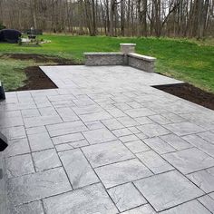 an outdoor patio with stone steps and benches