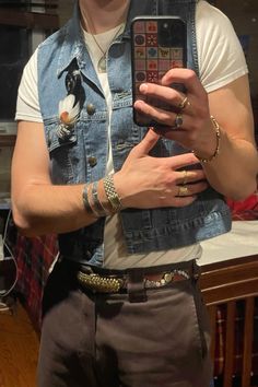 Men’s denim vest outfit aesthetic. Gold and silver jewlery. 70s belt. Cowboy boots Cowboy Vest Outfit Men, Jean Vest Outfits Men, Mens Fashion Vest, Jeans Vest Outfit Men, Festival Cowboy Outfit, Cowboy Modern Outfit Men, Cowboy Aesthetic Outfits Men, Mens Denim Vest Outfit, Masc Cowboy Outfit