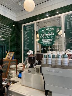 a coffee shop with people working behind the counter