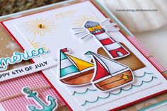 a close up of a card with a sailboat on it and an anchor in the background