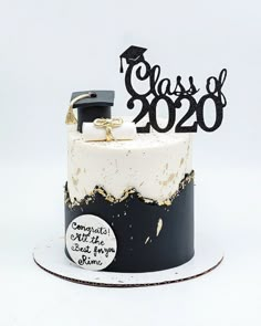 a black and white graduation cake with gold accents