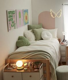 a bedroom with a bed, nightstands and pictures on the wall