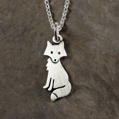 "This sweet little fox is made of sterling silver. The pendant is quite TINY, measuring about 3/4\" (2 cm) from the tip of the ears to the tip of the tail.  So cute! You can purchase just the pendant/charm, or complete the necklace with a sterling silver chain.  For the matching fox earrings:  https://www.etsy.com/listing/188322134/tiny-fox-earrings © Stick Man Creations This is our own original design, handcrafted by us, and signed on the back with our logo.   For more information about the cre Handmade Cute Sterling Silver Charm Necklaces, Cute Sterling Silver Pendant Charm Necklace, Cute Sterling Silver Pendant Charm Necklaces, Cute Silver Pendant Charm Necklace, Whimsical Sterling Silver Pendant Charm Necklace, Whimsical Sterling Silver Pendant Necklace, Cute Nickel-free Sterling Silver Necklaces, Cute Silver Sterling Silver Charm Necklaces, Cute Handmade Sterling Silver Necklaces