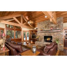 a living room filled with furniture and a fire place in the middle of a room