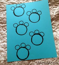 an image of mickey mouse ears on a sheet of blue paper with black outlines