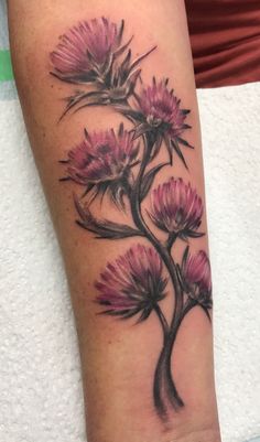 a woman's arm with pink flowers on it