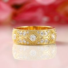 a close up view of a gold ring with diamonds