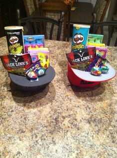 two cups on top of a table filled with candy