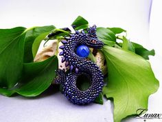 Original pendant depicting a dragon guarding an egg. Made with great care and precision from Toho, Miyuki and Czech FP beads, the dragon egg is an agate ball. The whole thing is hung on a braided strap 48 cm / 18.9inch long Dragon height 8cm / 3.14inch dragon width 4 cm / 1.57inch I can make a dragon in other colors - just write to me:) Fantasy Beaded Jewelry As Gift, Blue Amulet Beads For Gifts, Handmade Blue Fantasy Jewelry, Blue Amulet Beads For Gift, Unique Pendant Beads As Gift, Handmade Blue Amulet Beads, Fantasy Blue Jewelry For Jewelry Making, Blue Fantasy Jewelry For Jewelry Making, Long Dragon