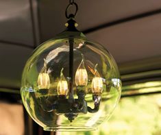 a glass ball light hanging from a ceiling