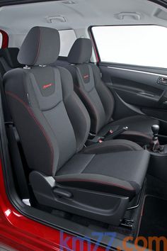 the interior of a red car with black seats