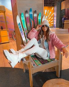 a woman is sitting in a chair with skis on the back and feet up