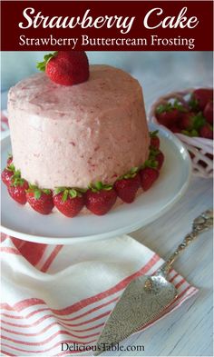 strawberry cake on a white plate with strawberries in the background and text overlay that reads strawberry cake strawberry buttercream frosting