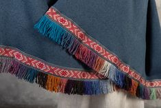 Latvian folk style wide scarf, shoulder shawl with fringes. A nice gift to warm someone up. The soft fabric is used for the base. Edging decorated with wool fringes and woven decorative ribbon. With -77 cm Length of 215 cm You can choose blue, white, grey! Made by SandrasMagic for You! Traditional Fringed Poncho Shawl, Bohemian Weaving Shawl For Fall, Bohemian Shawl With Woven Motifs For Winter, Handmade Folk Shawl For Winter, Winter Bohemian Shawl With Woven Motifs, Bohemian Fall Shawl With Weaving, Traditional Winter Festival Shawl, Traditional Fringed Shawl Scarf, Traditional Shawl Scarf With Fringe