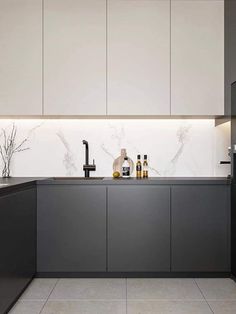 a kitchen with marble counter tops and white cabinets