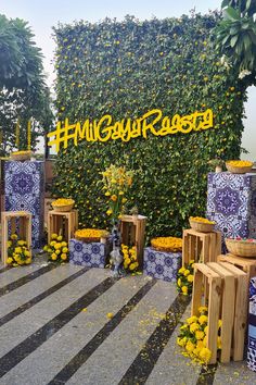 an outdoor display with yellow flowers and blue tiles