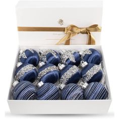 blue and silver christmas ornaments in a white box