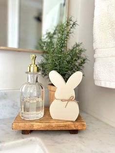 a bathroom counter with a soap dispenser and bunny shaped bottle on it