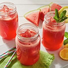 three mason jars filled with watermelon and limeade on top of a table