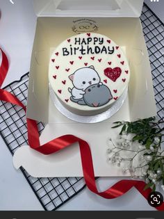 a happy birthday cake with an image of a hippo on it and red ribbon