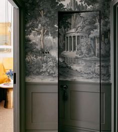 an open door leading to a room with a mural on the wall