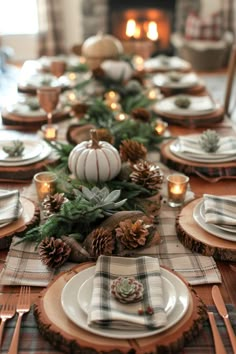 the table is set with plates, silverware and plaid napkins for an elegant look