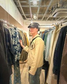 a man standing in front of a rack of clothes