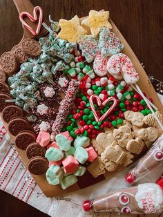 a platter filled with lots of different types of cookies and candy on top of a table