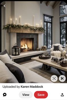 a living room filled with furniture and a fire place in front of a large window