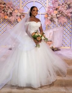 a woman in a white wedding dress posing for the camera