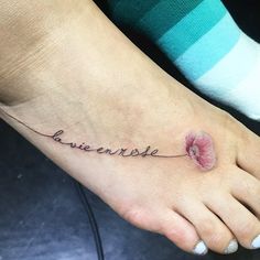 a woman's foot with the word love written in cursive writing on it