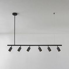 five lights hanging from the ceiling in a room