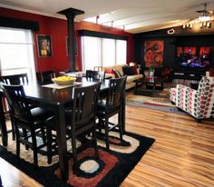 a dining room table with chairs and a television in the backgroung area