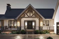 a house that is lit up at night with lights on the front and side windows