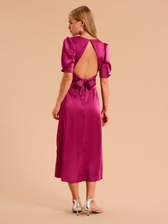 Odette is elegance with an edge. The 3/4 length sleeves are gathered at the bottom to create a feminine silhouette offset with a deep v-neckline. With an open back with sash detail, this dress in deep magenta recycled satin is a date night dream. Spring Midi Dress With Tie Back For Dinner, Elegant Pink Dress With Ruched Back, Satin Midi Dress With Tie Back For Brunch, Silk Dress With Ruched Back For Date Night, Spring Satin Midi Dress With Back Opening, Elegant Satin Dress With Ruched Back For Spring, Pink 3/4 Sleeve Midi Dress For Party, Pink Midi Dress With 3/4 Sleeves For Party, Satin Short Sleeve Midi Dress For Date Night