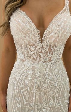 the back of a wedding dress with beading and sequins