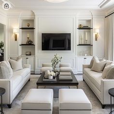 a living room filled with furniture and a flat screen tv mounted to the side of a wall