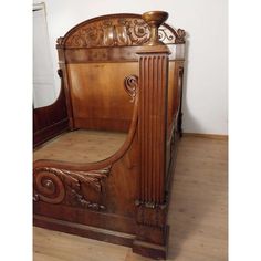 an antique wooden bed frame with carved details